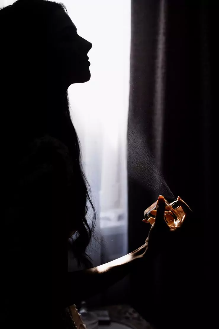 silhouette-young-girl-who-is-perfuming-front-window-darkness